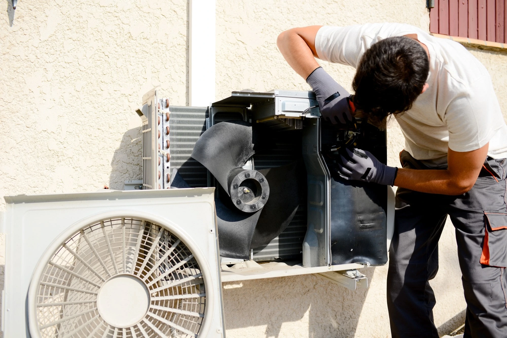 Man Working On Outdoor Compressor Unit